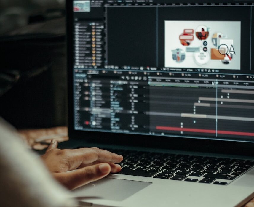 person using macbook pro on table